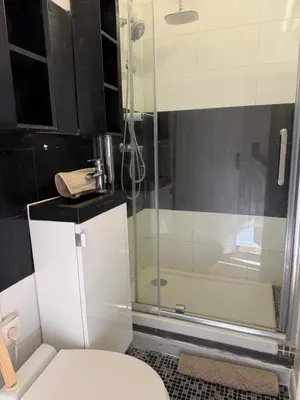 a bathroom with a toilet and a glass shower at Studio Moderne à 10 min à pied Palais & Plages in Cannes