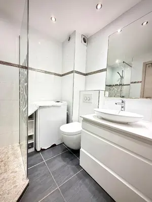 a white bathroom with a toilet and a sink at Luxury Cannes Suite Terrace Walk to Palais in Cannes