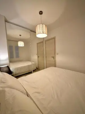 a bedroom with a bed and a mirror at Luxury Cannes Suite Terrace Walk to Palais in Cannes