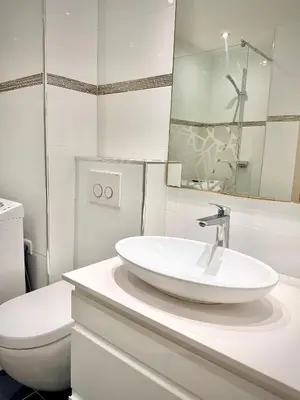 a white bathroom with a sink and a toilet at Luxury Cannes Suite Terrace Walk to Palais in Cannes