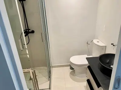 a bathroom with a toilet and a glass shower at Coastal Retreat Studios with Balcony in Cannes