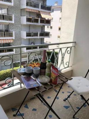 a table on a balcony with food and drinks at Coastal Retreat Studios with Balcony in Cannes