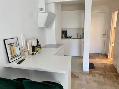 a kitchen with white cabinets and a white counter top at Coastal Retreat Studios with Balcony in Cannes
