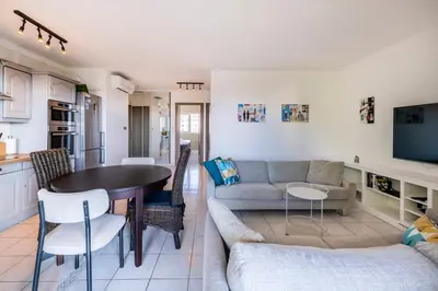 a living room with a couch and a table at Two bed - Walk to the beach in Cannes