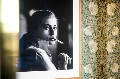 a black and white photo of a woman smoking a cigarette at Luxury apartment in Cannes in Cannes