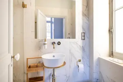 a bathroom with a white sink and a mirror at Luxury apartment in Cannes in Cannes