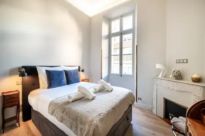 a bedroom with a large bed and a fireplace at Luxury apartment in Cannes in Cannes