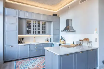 a kitchen with blue cabinets and a white counter top at Luxury apartment in Cannes in Cannes