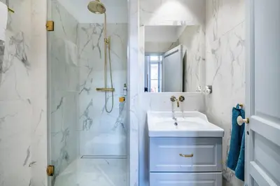 a white bathroom with a sink and a shower at Luxury apartment in Cannes in Cannes