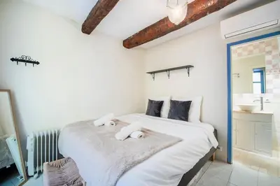 a bedroom with a bed with towels on it at Charming 1-Bedroom Townhouse in Cannes