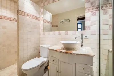 a bathroom with a toilet and a sink at Charming 1-Bedroom Townhouse in Cannes