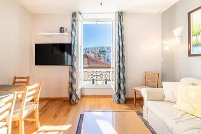 a living room with a couch and a table at Two Bedrooms - 250m to the beach in Cannes