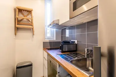 a small kitchen with a sink and a microwave at Two Bedrooms - 250m to the beach in Cannes