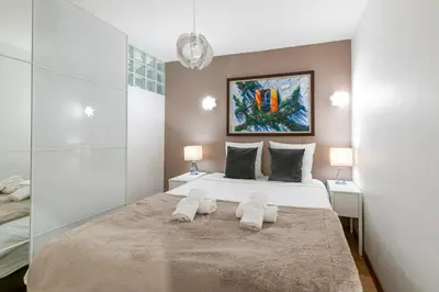 a bedroom with a large bed with two towels on it at Two Bedrooms - 250m to the beach in Cannes