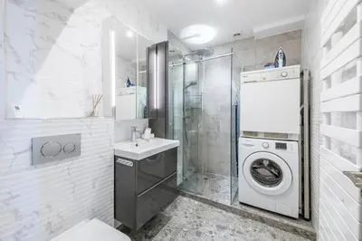 a bathroom with a washing machine and a sink at Two Bedrooms - 250m to the beach in Cannes