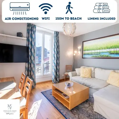 a living room with a couch and a table at Two Bedrooms - 250m to the beach in Cannes