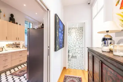a kitchen with a refrigerator and a shower at Private Garden 3-Bed in Cannes in Cannes