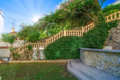 a stone retaining wall with a staircase and plants at Private Garden 3-Bed in Cannes in Cannes