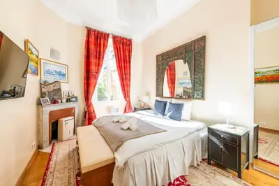 a bedroom with a large bed and a window at Private Garden 3-Bed in Cannes in Cannes