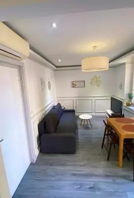 a living room with a couch and a table at Smart 2 Apart - Le 62 Cannes in Cannes