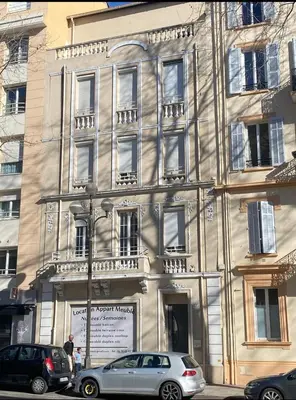 a building with cars parked in front of it at Smart 2 Apart - Le 62 Cannes in Cannes