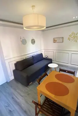 a living room with a couch and a table at Smart 2 Apart - Le 62 Cannes in Cannes