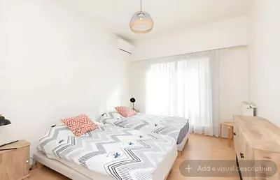 a white bedroom with a bed and a window at Croisette Top Floor 2BR with Bay View Balcony in Cannes