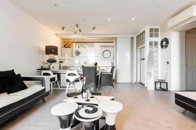 a living room with a couch and tables at Palais Prestige YourHostHelper in Cannes