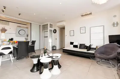 a living room with a couch and a table at Palais Prestige YourHostHelper in Cannes