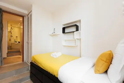a bedroom with a bed and a bathroom at Palais Prestige YourHostHelper in Cannes