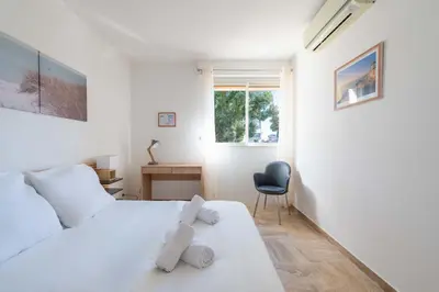 a bedroom with a bed and a desk and a chair at 2-Br Apartment with Terrace Near Cannes Centre in Cannes