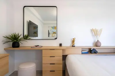 a bedroom with a desk and a mirror at L'HARMONIE DE CARNOT avec Balcon in Cannes