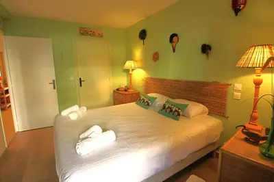 a bedroom with a large bed with white sheets and pillows at air-conditionned apartment 2 bedrooms & bathrooms with refined decoration in Cannes