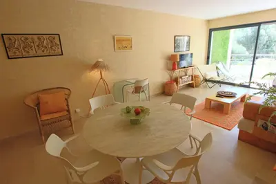 a living room with a table and chairs at air-conditionned apartment 2 bedrooms & bathrooms with refined decoration in Cannes