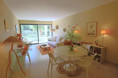 a living room with a table and a couch at air-conditionned apartment 2 bedrooms & bathrooms with refined decoration in Cannes