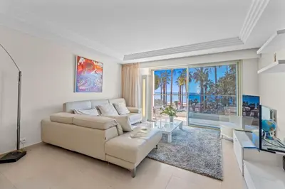 a living room with a couch and a table at REF 2052 - Seasonal rental - Prestigious apartment on the Croisette Cannes in Cannes