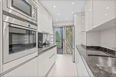 a white kitchen with a sink and a stove at REF 2052 - Seasonal rental - Prestigious apartment on the Croisette Cannes in Cannes