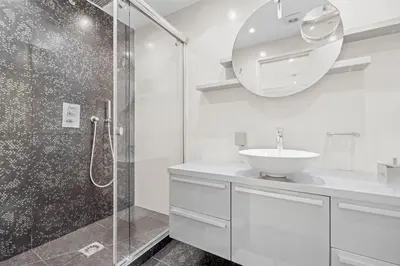 a white bathroom with a sink and a shower at REF 2052 - Seasonal rental - Prestigious apartment on the Croisette Cannes in Cannes