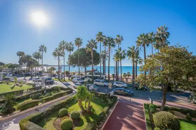 an aerial view of a parking lot with palm trees and cars at REF 2052 - Seasonal rental - Prestigious apartment on the Croisette Cannes in Cannes