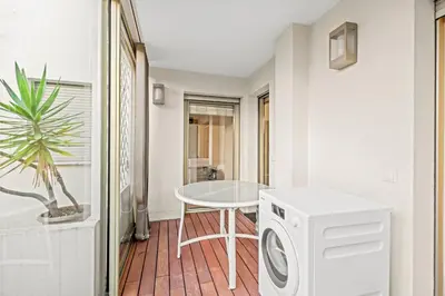 a laundry room with a washing machine and a table at REF 2052 - Seasonal rental - Prestigious apartment on the Croisette Cannes in Cannes