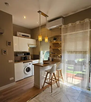 a kitchen with a table and chairs in a room at Bright studio apartment with terrace in Cannes in Cannes