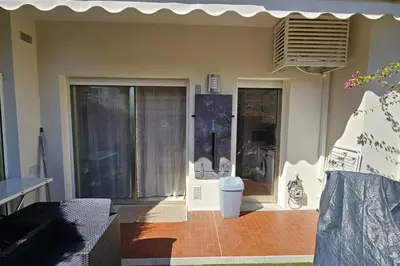 a house with a patio with a motorcycle outside of it at Bright studio apartment with terrace in Cannes in Cannes