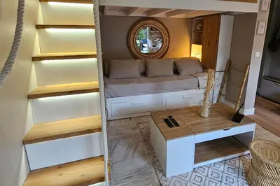 a living room with a couch and a table at Bright studio apartment with terrace in Cannes in Cannes