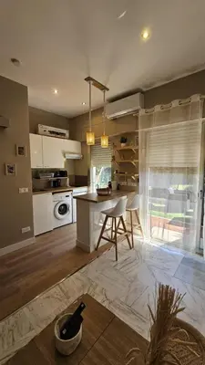 a kitchen with a table and a dining room at Bright studio apartment with terrace in Cannes in Cannes
