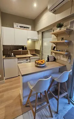 a kitchen with a counter with a bowl of fruit on it at Bright studio apartment with terrace in Cannes in Cannes