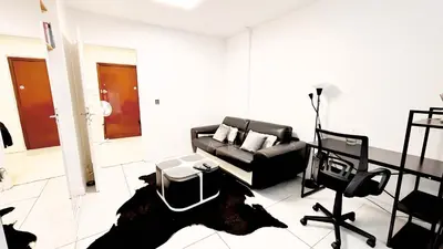 a living room with a couch and a table at Proche Centre ville, 1 chambre, balcon - Palmazur Vacances in Le Cannet