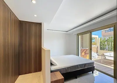 a bedroom with a bed and a sliding glass door at New Modern rooftop 2 ch 4 peoples Clim Wifi in Le Cannet