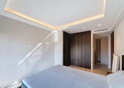 a bedroom with a bed and a wooden door at New Modern rooftop 2 ch 4 peoples Clim Wifi in Le Cannet