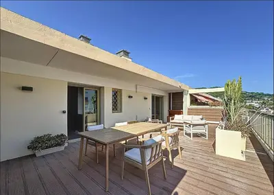 a patio with a table and chairs on a deck at New Modern rooftop 2 ch 4 peoples Clim Wifi in Le Cannet