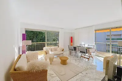 a living room with white furniture and a balcony at HENRI CAMILLE RE -Wios- 2 bedrooms APT - Huge terrace sea view in Cannes